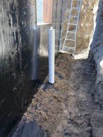 Trenches were dug to make way for the basement perimeter drain pipe that leads to the sump pump that will prevent ground water flooding